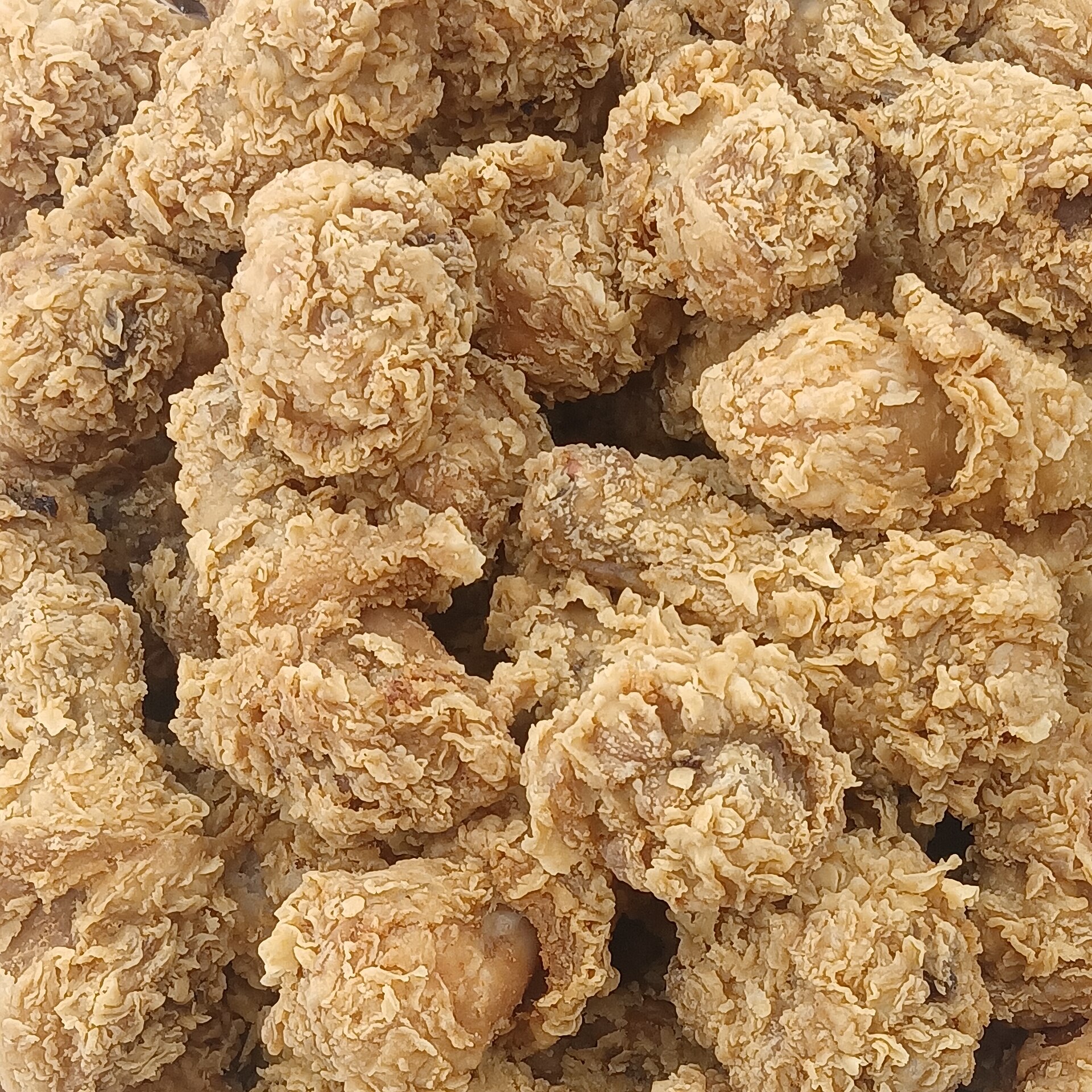 Close-up of shaggy, flaky fried chicken crust